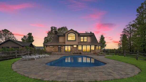 A house with a swimming pool surrounded by a stone patio, a wooden fence, and a well-maintained lawn. - Saratoga's Musical Oasis|Heated Pool|King Bed|Mountain Views| (Greenfield center)