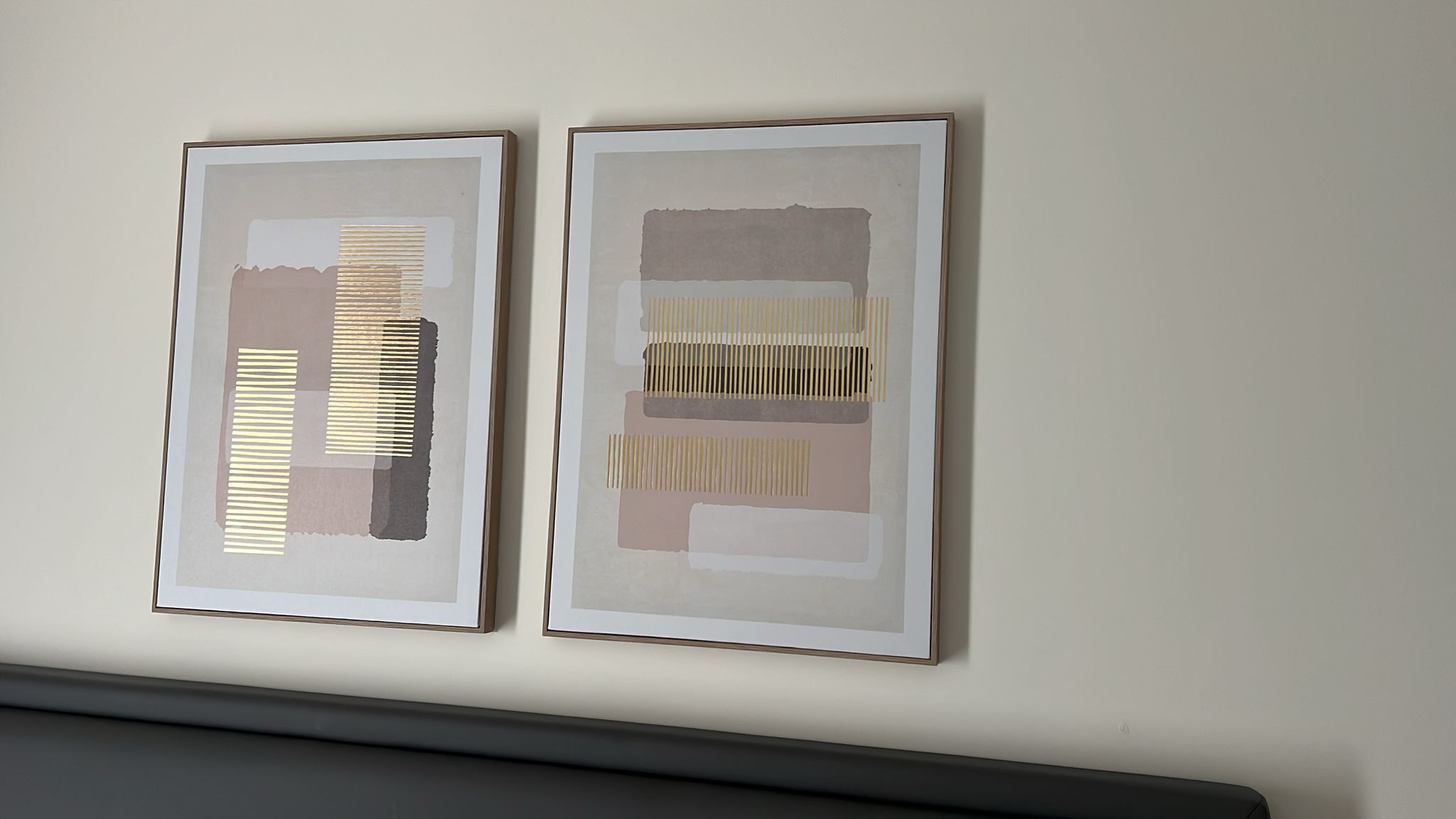 Due opere d'arte astratte incorniciate su una parete neutra.