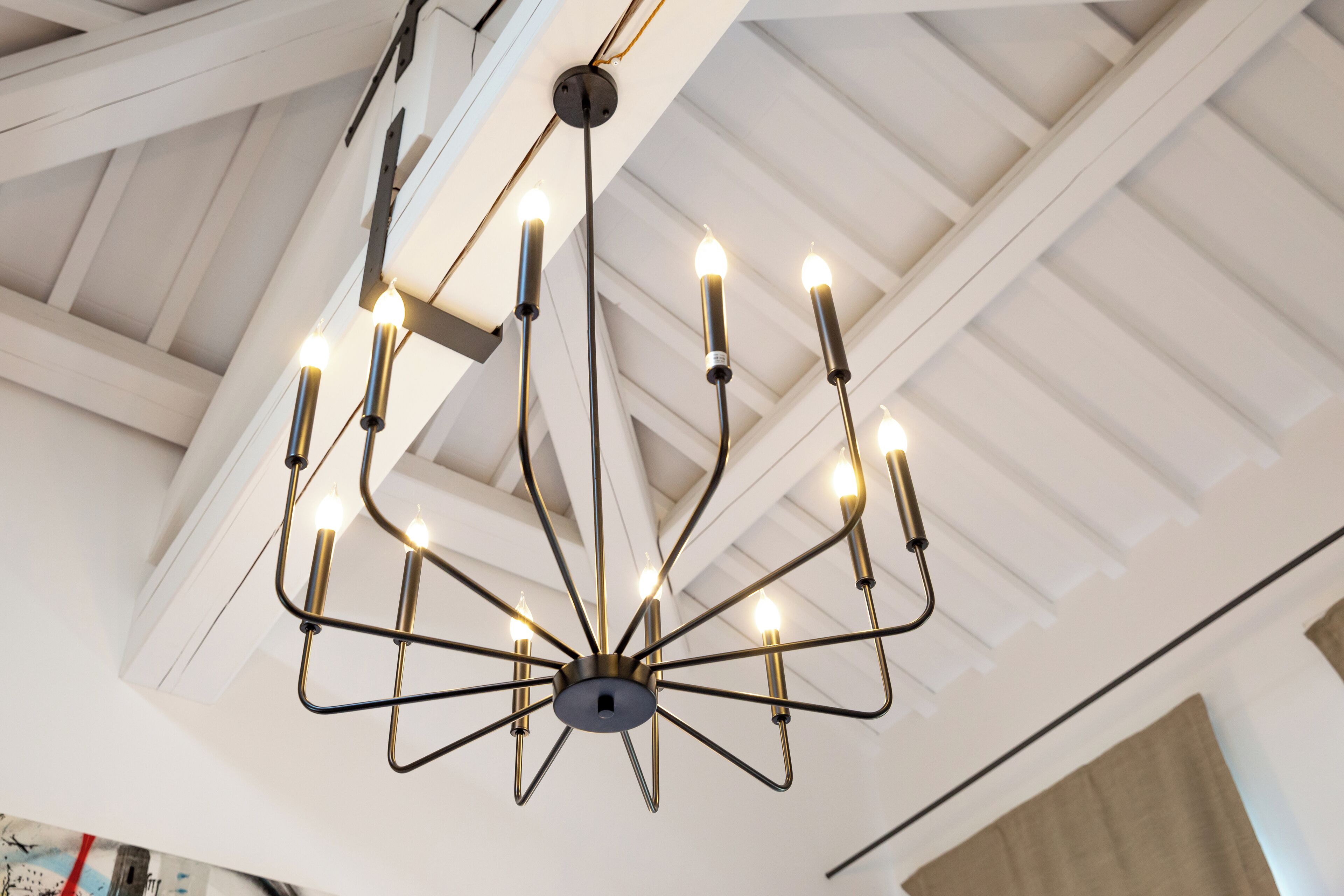 A chandelier with multiple arms and candles.