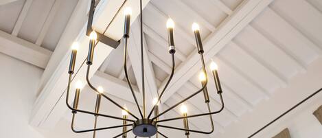 A chandelier with multiple arms and candles.