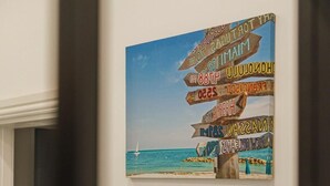A wall with a signpost featuring multiple directional signs.