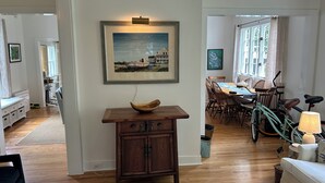 A dining area with a table, chairs, and a bicycle. - 3-bedroom historic vacation home newly renovated in the middle of Oxford MD. (Oxford)