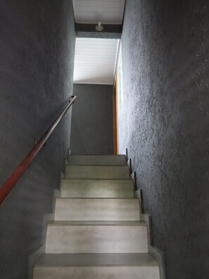 Staircase leads to an upper floor with a window at the top.