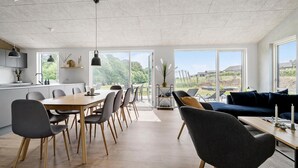 A modern kitchen with a dining area, large windows, and a view of the outdoors. - Awesome home in Haderslev with sauna (Haderslev)