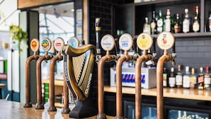 A bar with multiple beer taps and a selection of liquor bottles in the background. -  Carnmore Hotel Lower Hutt (Lower Hutt)