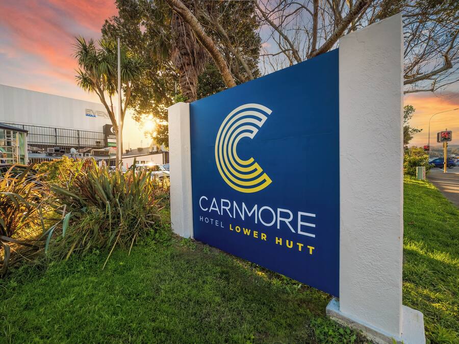 A sign for the Carnmore Hotel Lower Hutt with a logo and name.