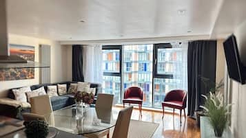 Family Apartment | Living area | 50-inch Smart TV with satellite channels