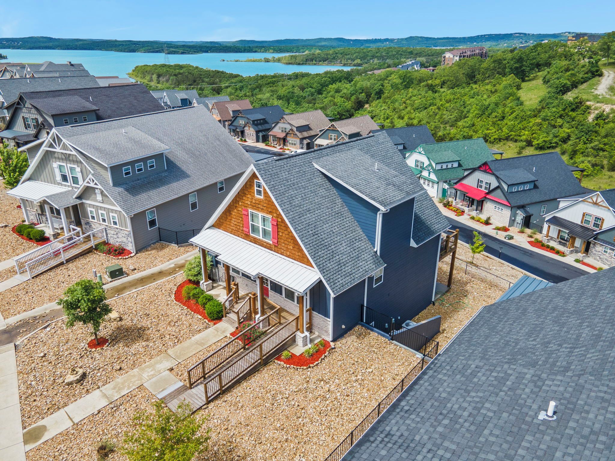 A residential area with houses, a dock, and a lake.