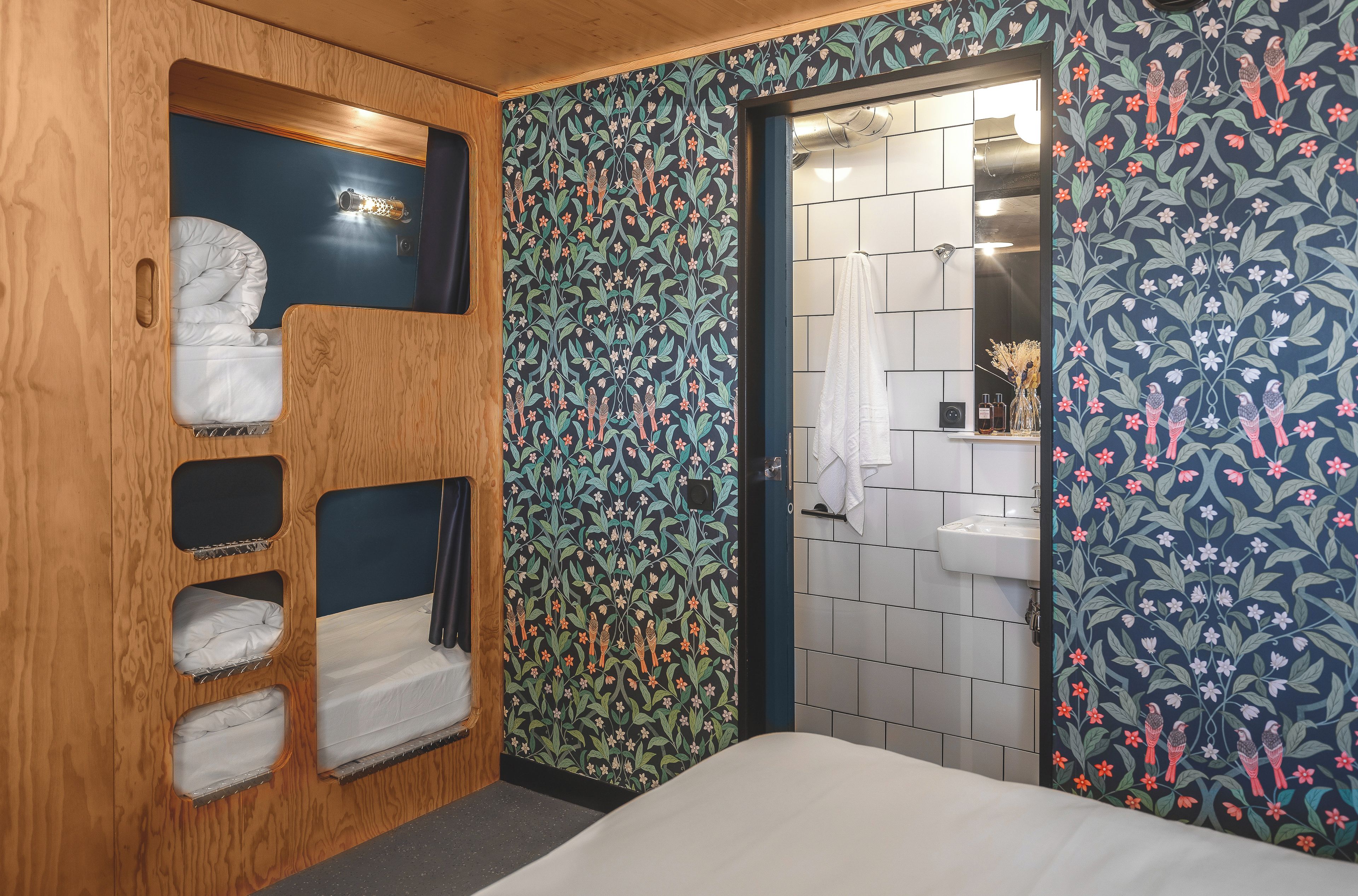 Un baño pequeño con tocador de madera, zona de ducha y cama.