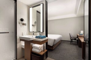 A hotel room with a large mirror, a sink, a bed, a desk, and a chair. - Days Inn by Wyndham Lanzhou Chengguan (Lanzhou)
