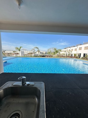 A view of a swimming pool with a view of a residential area in the background. - Puerto Vallarta Altavela Egina 57 (Valle de Banderas)