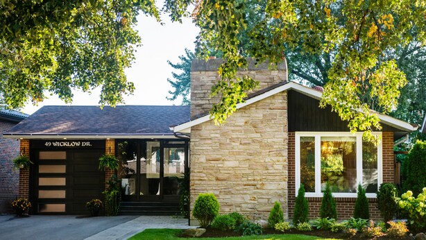 A two-story house with a garage labeled '49 WICKLOW DR.' and a stone facade.