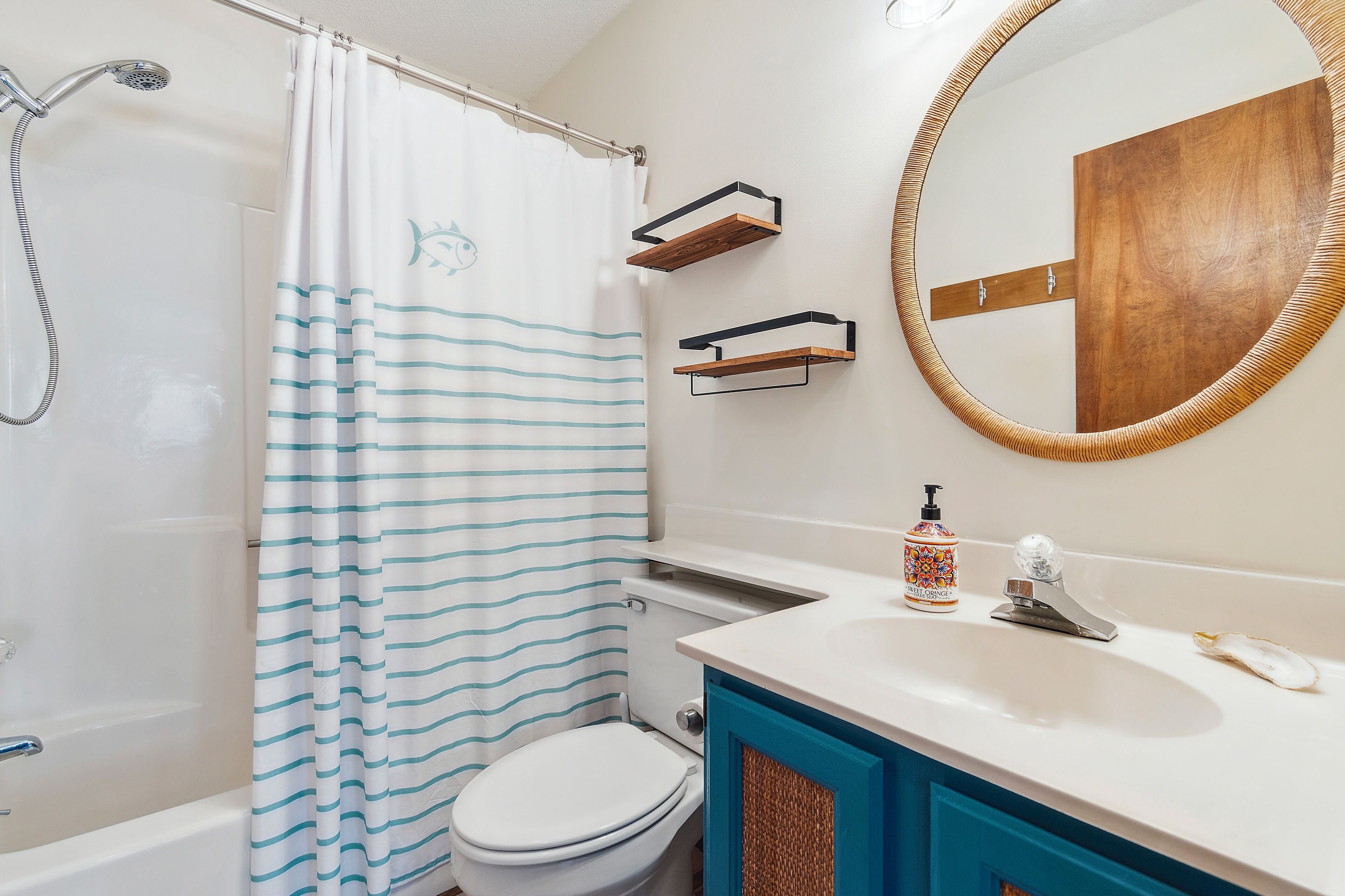 A bathroom with a shower, toilet, and sink.