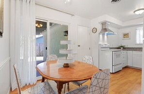 Enjoy cooking in this well-equipped kitchen with an oven, stainless steel range hood, and spacious countertop.