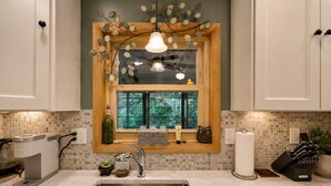 A kitchen with a built-in window, a stainless steel sink, and a coffee machine. - New Listing: On the Rocks in the Hideout (Lake Ariel)