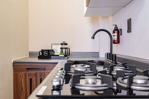 Microwave, stovetop, coffee/tea maker, cookware/dishes/utensils