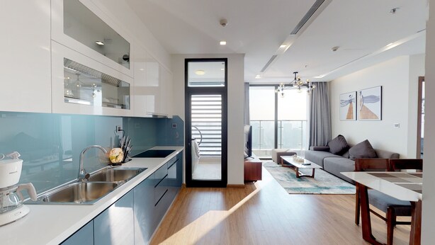 A modern apartment with a kitchen, dining area, and living room. - Royal Condotel in Vinhomes Metropolis (Hanoi)