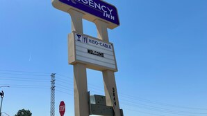 A sign for 'EGENCY INN' with a 'WELCOME' message and 'HBO-CABLE' symbol. - Regency Inn Fresno (Fresno)
