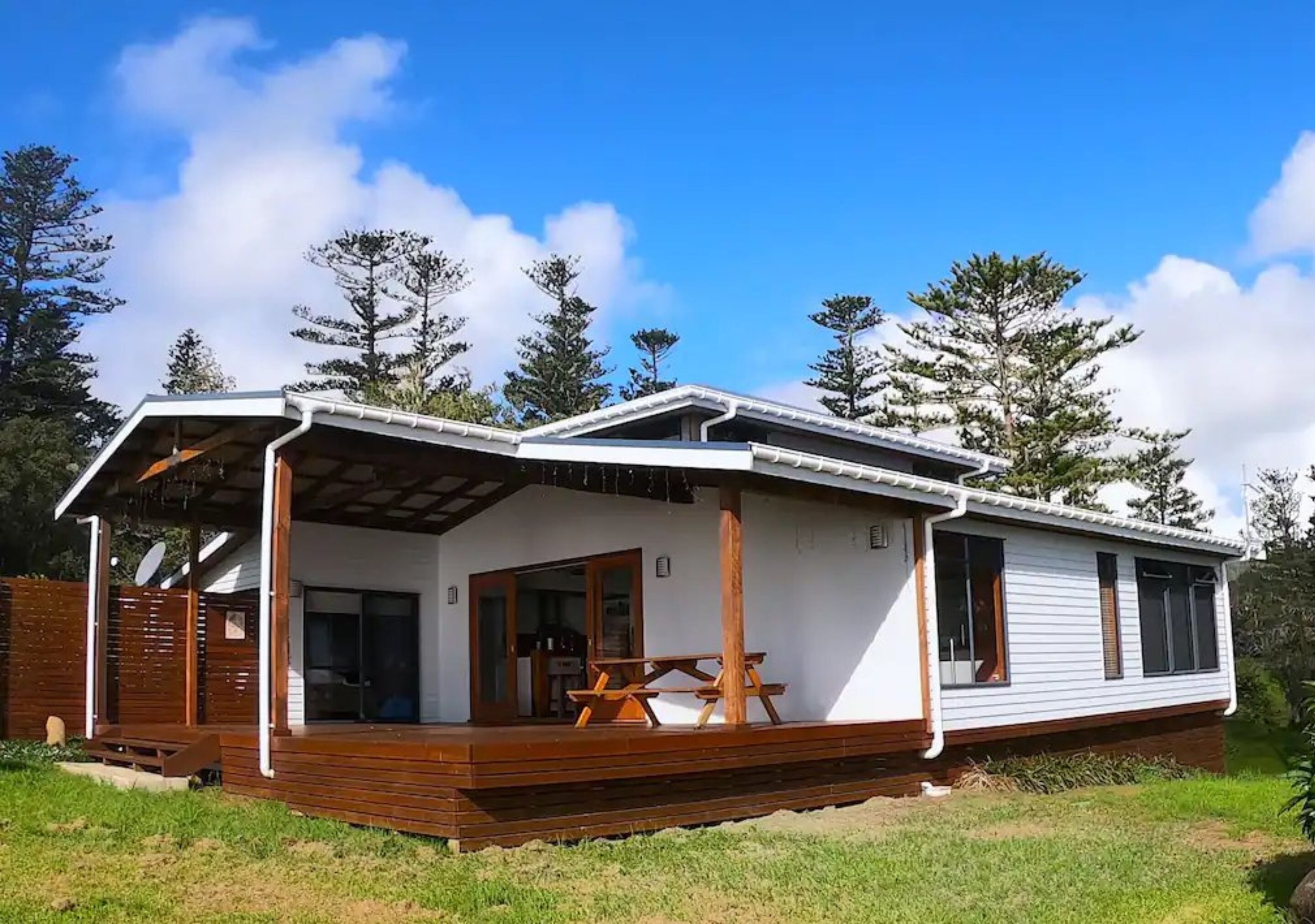 A single-story mobile home with a covered porch and a dining area.