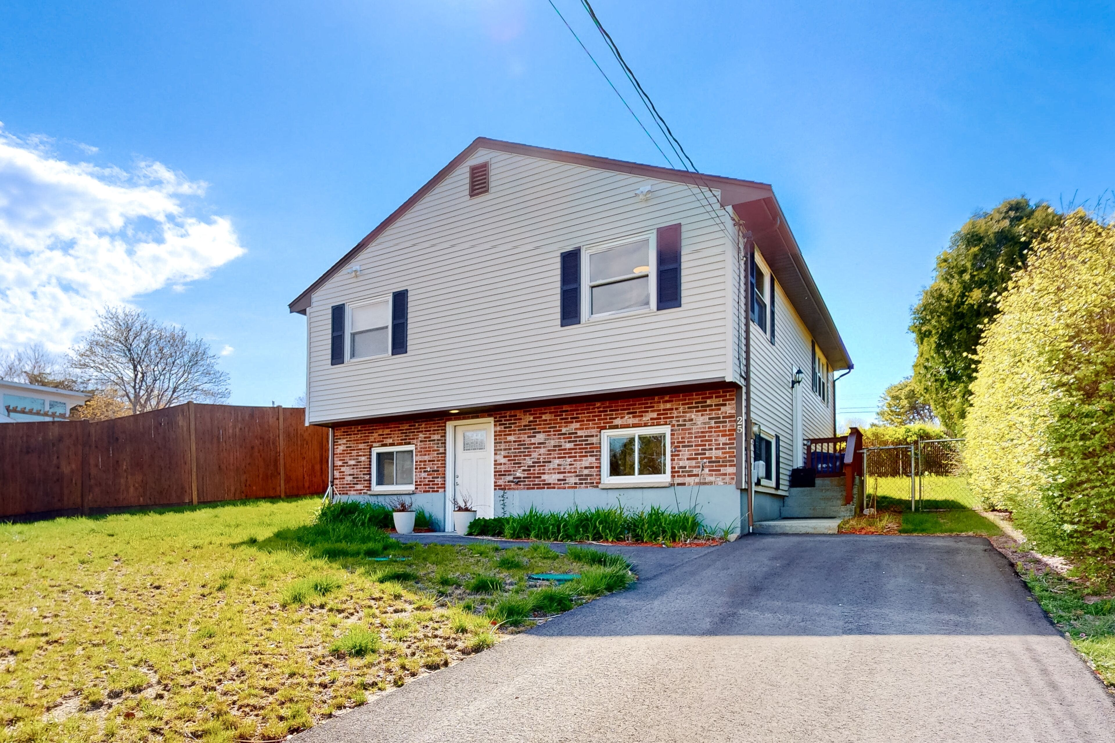 Two-story home near the beach with spacious deck, grill, modern kitchen, & W/D