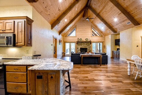 Riverfront cabin with private dock, firepit, wraparound porch & fireplace