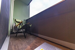A corner of a room with a chair, a radiator, and a window. - MATSUMIZAKA HILL by Tranova (Tokyo)
