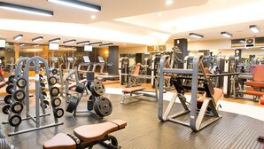 A gym with various exercise equipment, including treadmills, weight machines, and free weights. - Hotel Cianjur Cipanas (Cipanas)