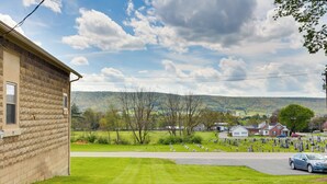 A rural landscape with a cemetery, a road, and a building with a brick facade. - Loganton Townhome, Near Fly Fishing & Hiking! (Loganton)