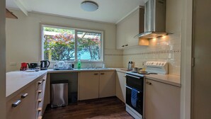 A compact kitchen with a window, a stove, and a sink. - Al'May Rawson escape, family cottage.
Entire Home in Rawson, Australia  (Rawson)