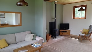 A cozy living room with a sofa, coffee table, and a fireplace.