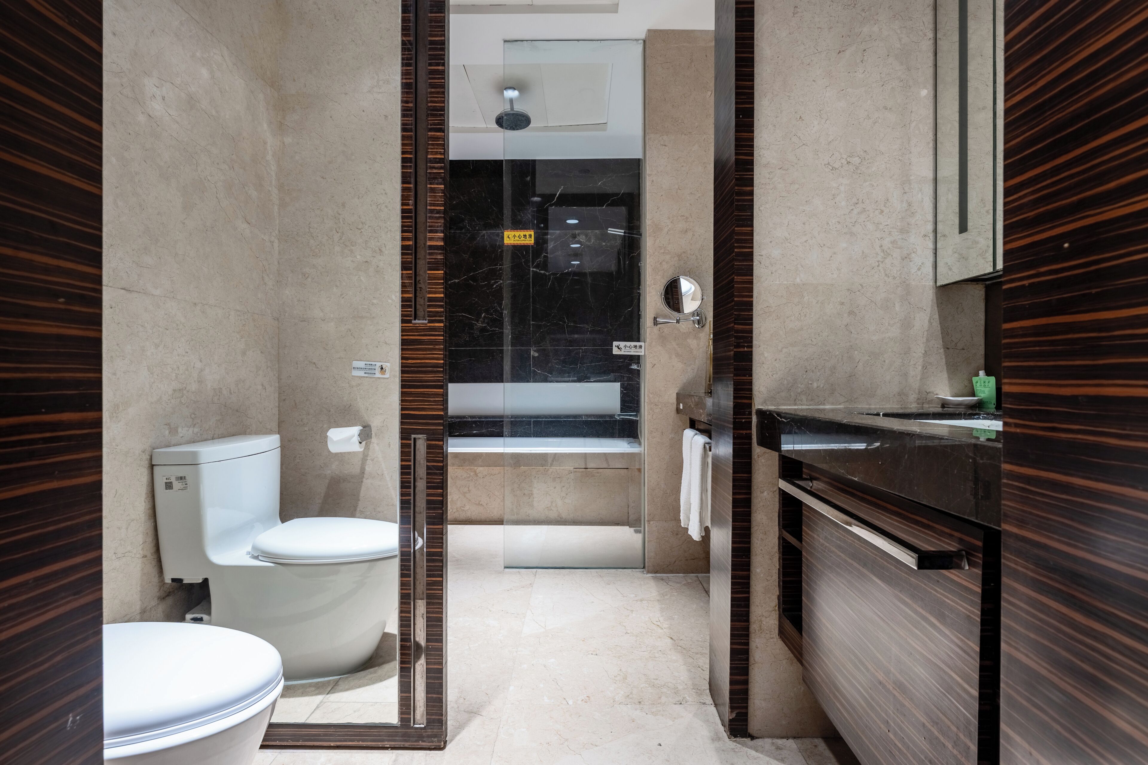 A modern bathroom with a toilet, sink, and shower area.