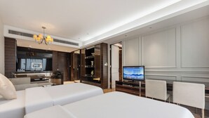 A hotel room with two beds, a TV, a dining area, and a kitchenette. - Side Apartment (Guangzhou)