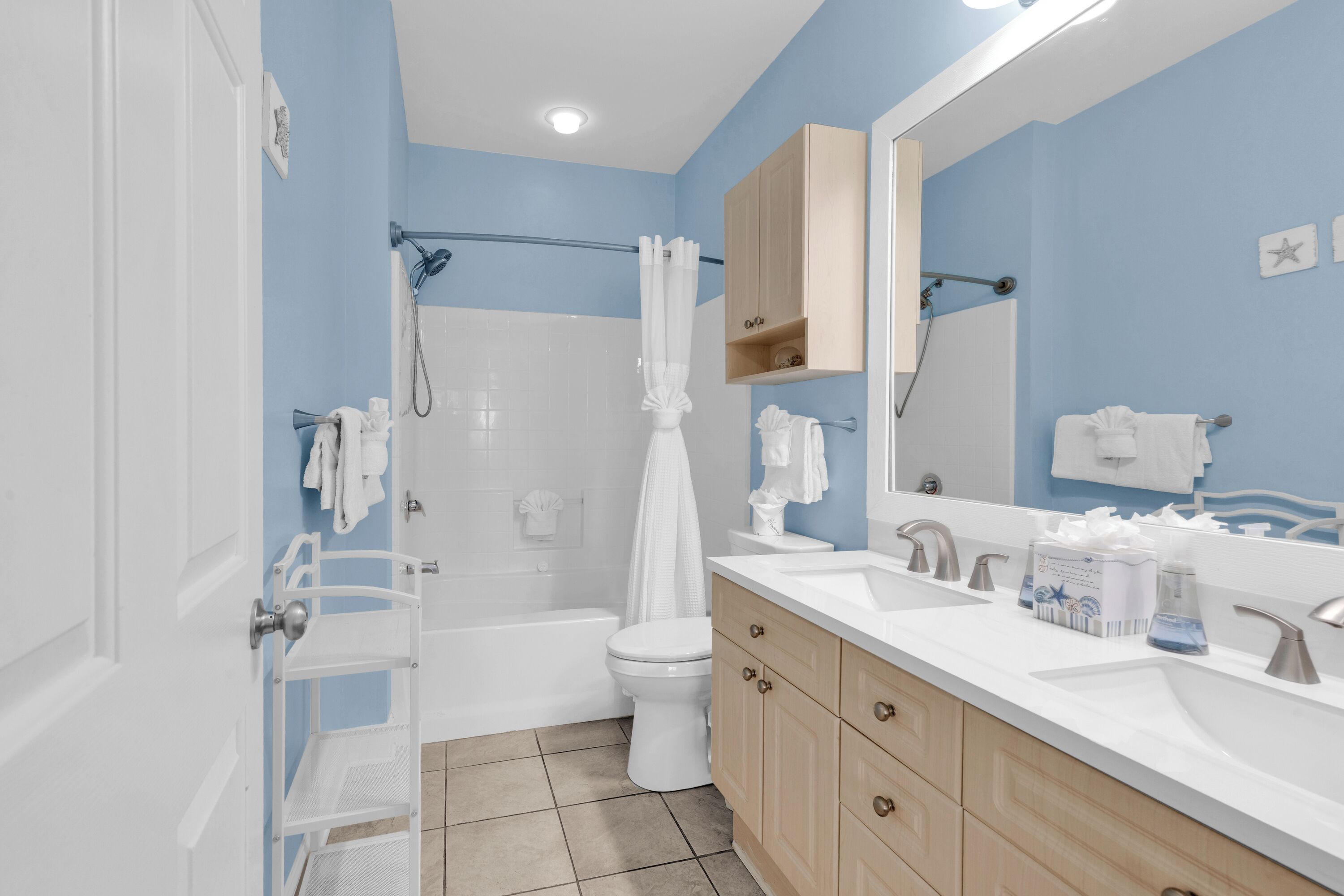 A bathroom with a bathtub, toilet, and sink.