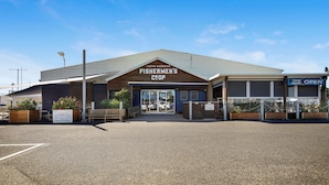 A building with a sign reading "Fishermen's Coop" at Coff's Harbour.