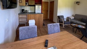 A compact living space with a kitchenette, a dining area, and a seating area. - Renovated 2-Room Ski-In/Ski-Out Apt with Pool & Wellness Center (Belle Plagne)