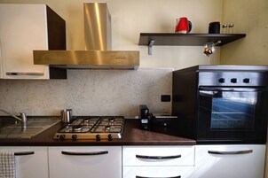 Apartamento, balcón, vistas al lago | Cocina privada | Frigorífico grande, horno, placa de cocina y máquina de café espresso