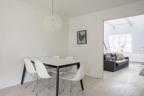 Enjoy a spacious dining area with a table and chairs, a cozy sofa, and a large window.