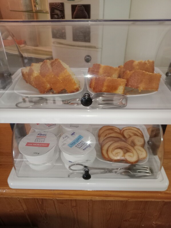 A breakfast display with pastries and yogurt. - Residencial Morgado (Almeida)