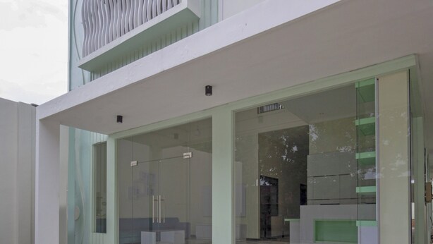 A modern building with large glass windows and a minimalist design. - Hotel O Irma's Residence (Blitar)