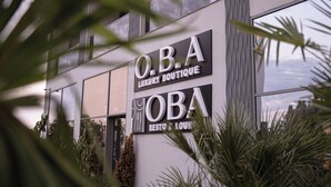 A modern building with a sign reading "O.B.A Luxury Boutique" and "O.B.A Rest & Lounge". - OBA LUXURY BOUTIQUE (Constanta)