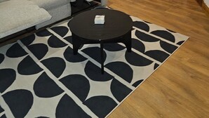 A living room with a sofa, a coffee table, and a dining area with a table and chairs. - Primely Located 1-bed Apartment in Brighton (Brighton)