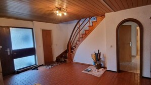 A staircase leading to a second floor, a door with frosted glass, and a small rug on the floor. - Completely Renovated House From 22 Euro pp and day (Baden-Baden)