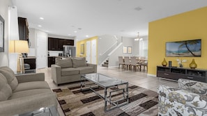 Relax in this spacious living area with a comfortable sofa, dining table, and kitchenette.