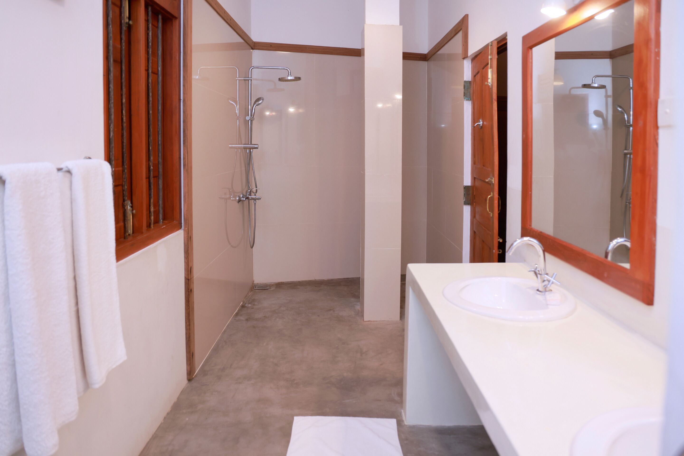 A bathroom with a shower, a sink, and a mirror.