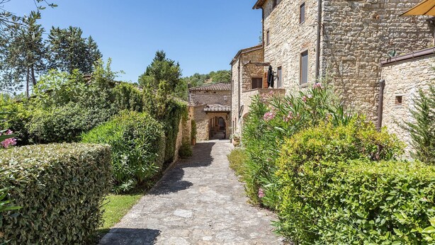 A stone building with a narrow pathway leading to an arched entrance. - Caravaggio, Galenda, Gaiole in Chianti, Siena and Chianti (Gaiole in Chianti)