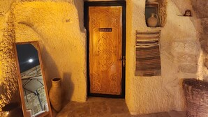 An arched stone doorway with a wooden door labeled "Sobesos."