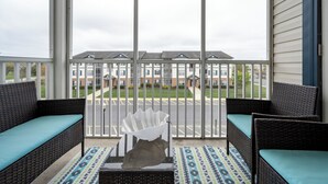 A balcony with wicker furniture and a patterned rug. - Villages of Five Points 3rd floor condo - great location & amenities! (Lewes)