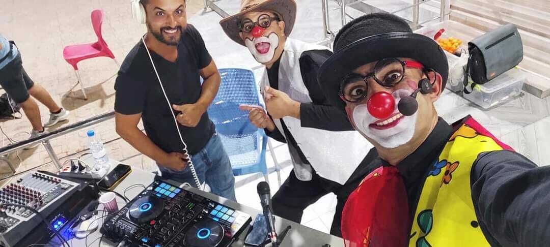 A DJ booth with electronic equipment and a microphone.