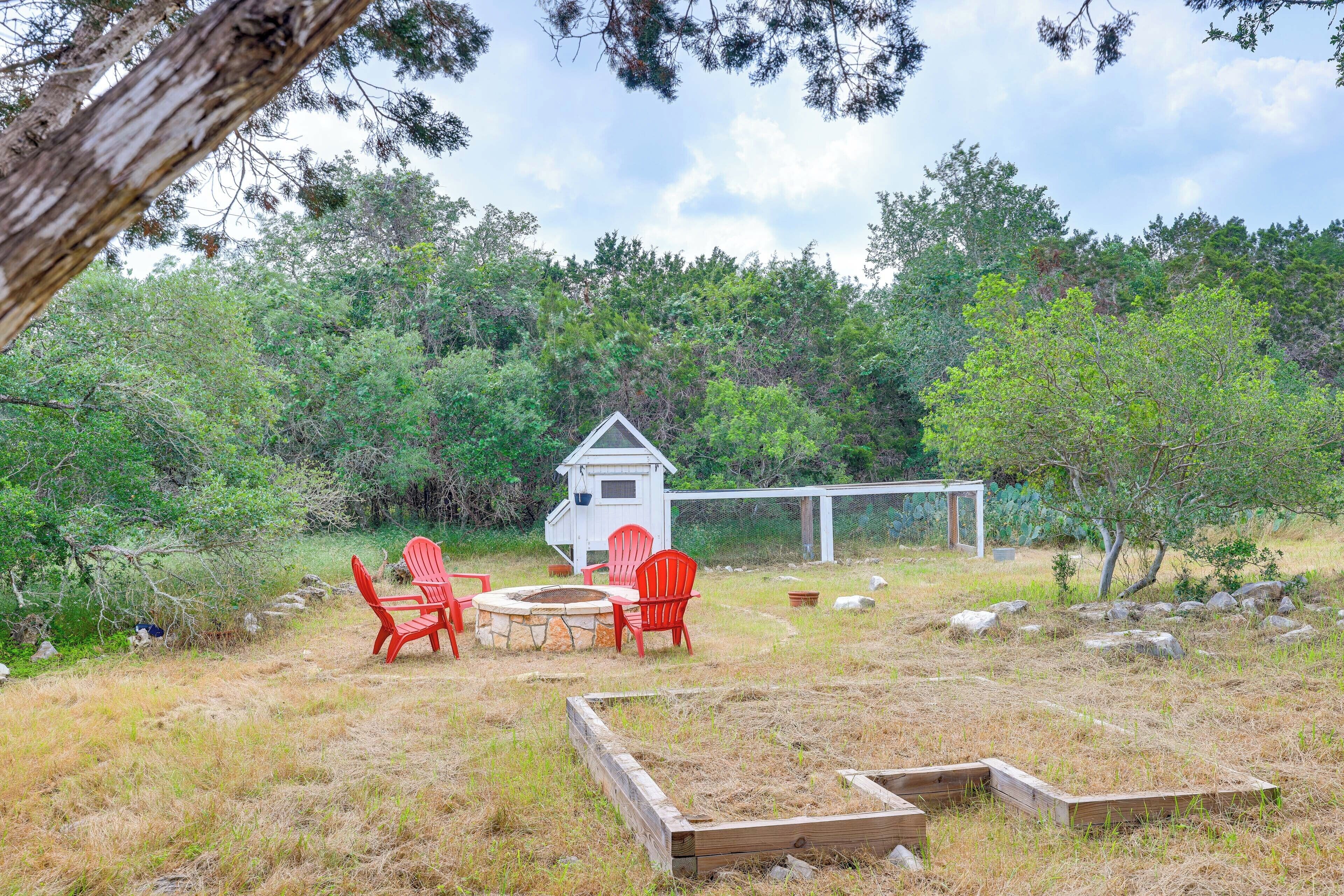 A rustic outdoor seating area with wooden benches and a small wooden structure.