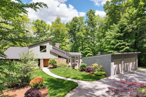 A modern two-story house with a covered patio, a garage, and a well-maintained lawn. - Lakefront Roxboro Home w/ Private Dock! (Roxboro)